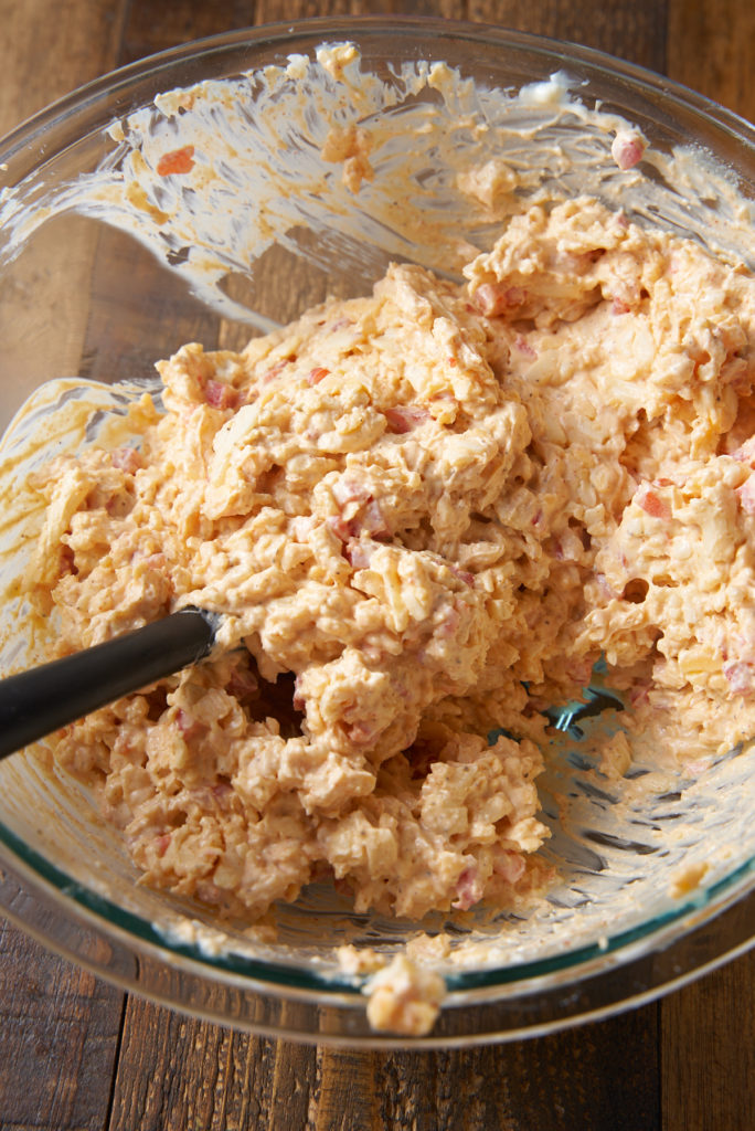 pimento cheese ingredients mixed in glass bowl