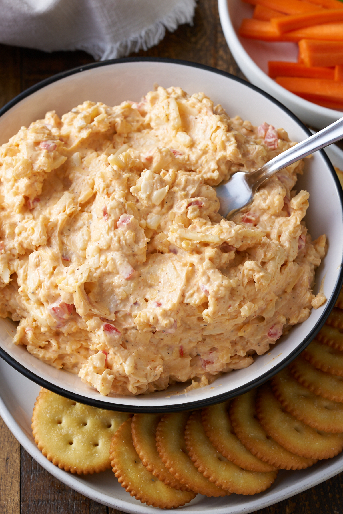pimento cheese on plate with cheese spreader in cheese and crackers on side