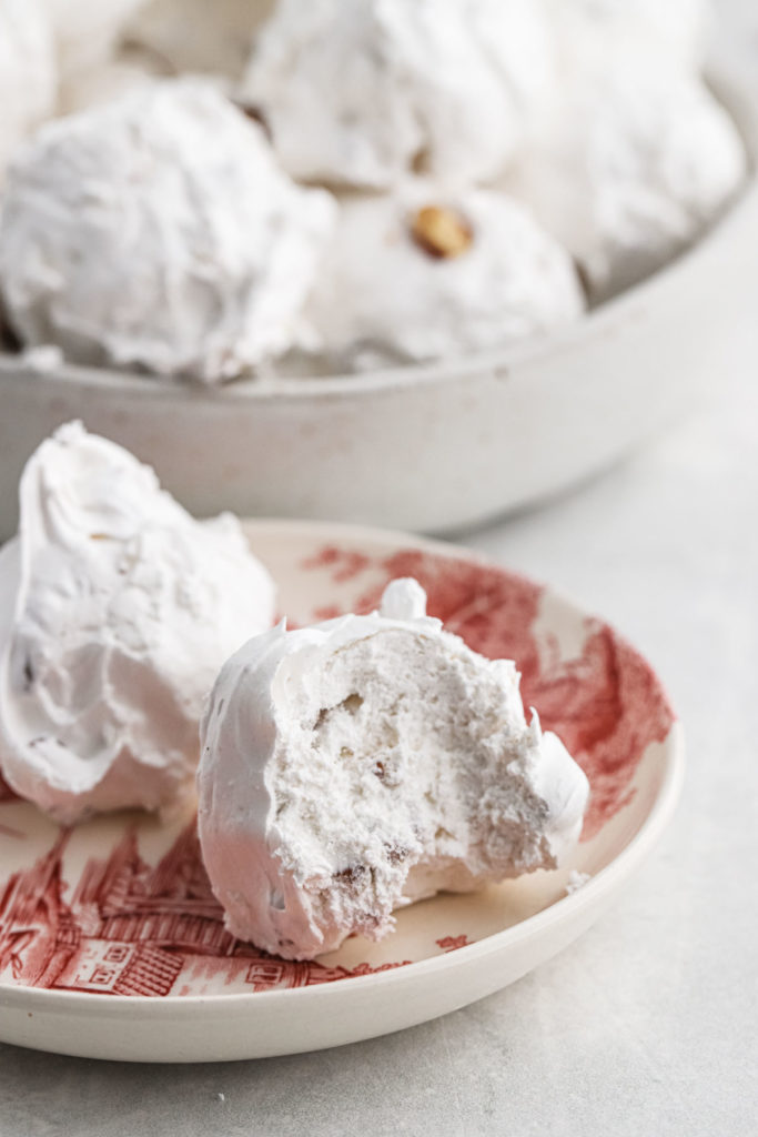 Maple divinity candy recipe with a bite missing on a red and white plate