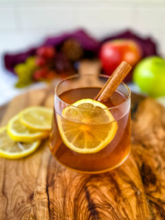 hot toddy apple cider in a glass cup with cinnamon
