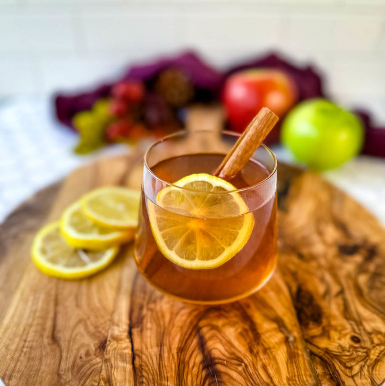 hot toddy apple cider in a glass cup with cinnamon
