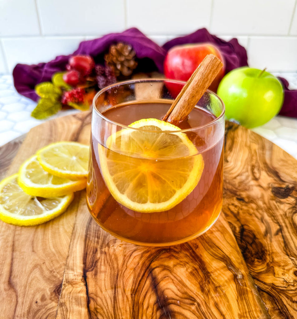 hot toddy apple cider in a glass cup with cinnamon
