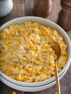 old fashioned cream corn in a plate with salt and pepper to the side