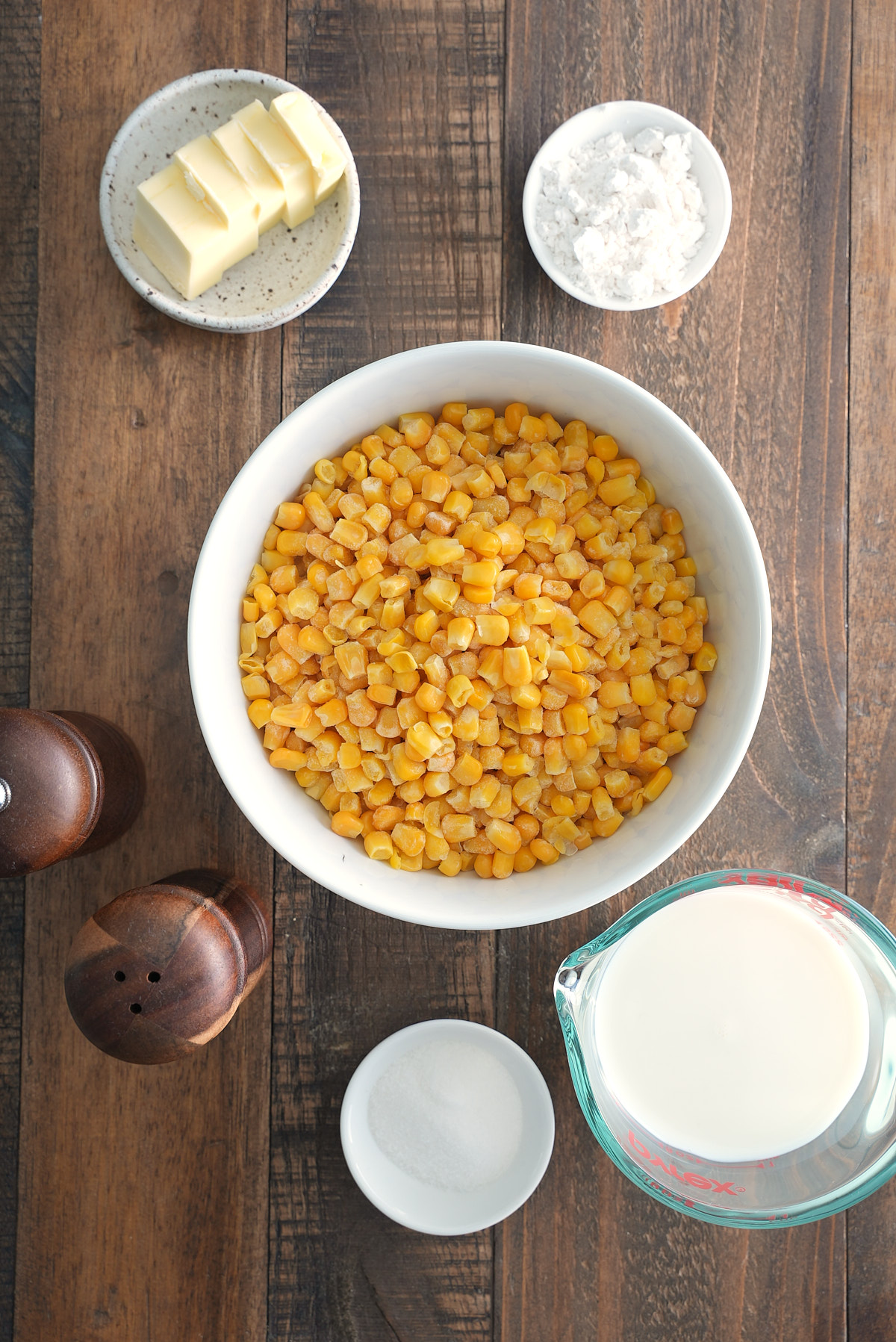 ingredients for creamed corn on wooden table