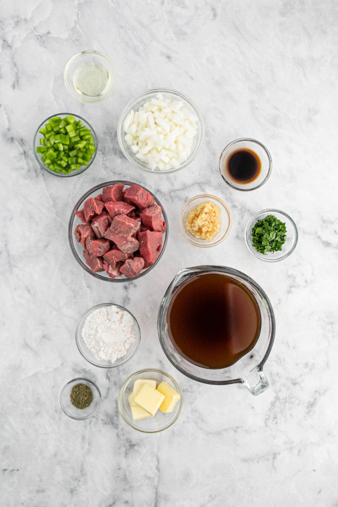 Ingredients to make rice and gravy in clear bowls