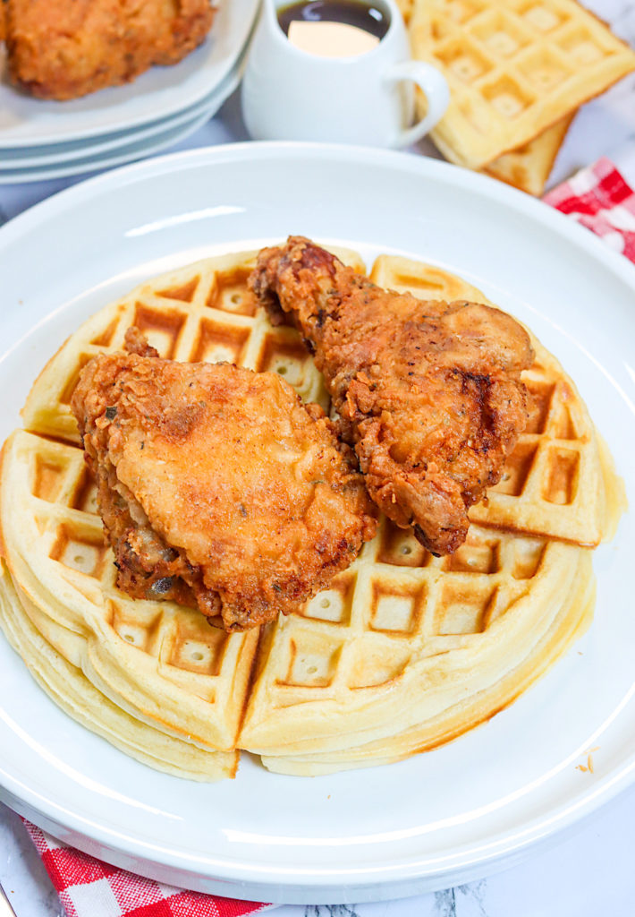 Freshly fried chicken topping hot of the griddle waffles