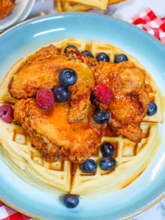Fried Chicken and Waffles topped with syrup and fruit for a decadent brunch or dinner