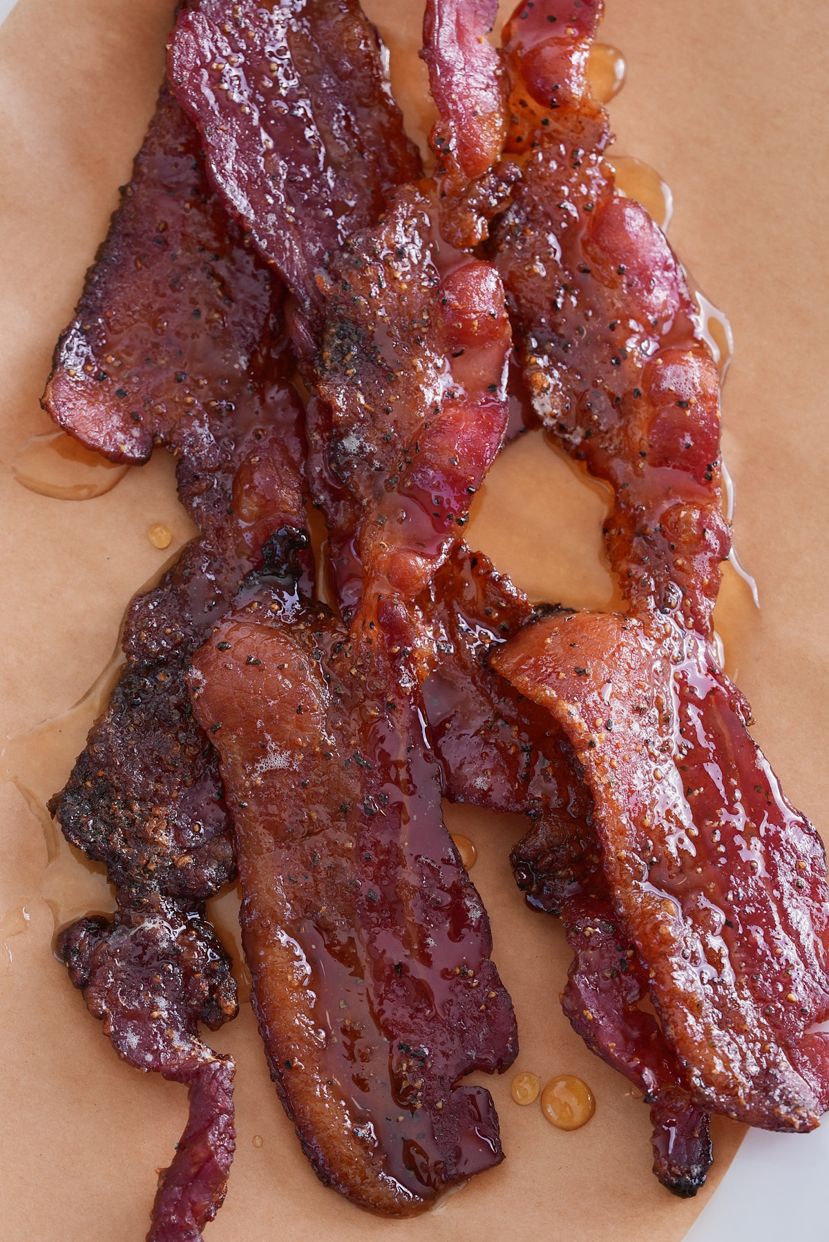 close up image of candied bacon on parchment paper