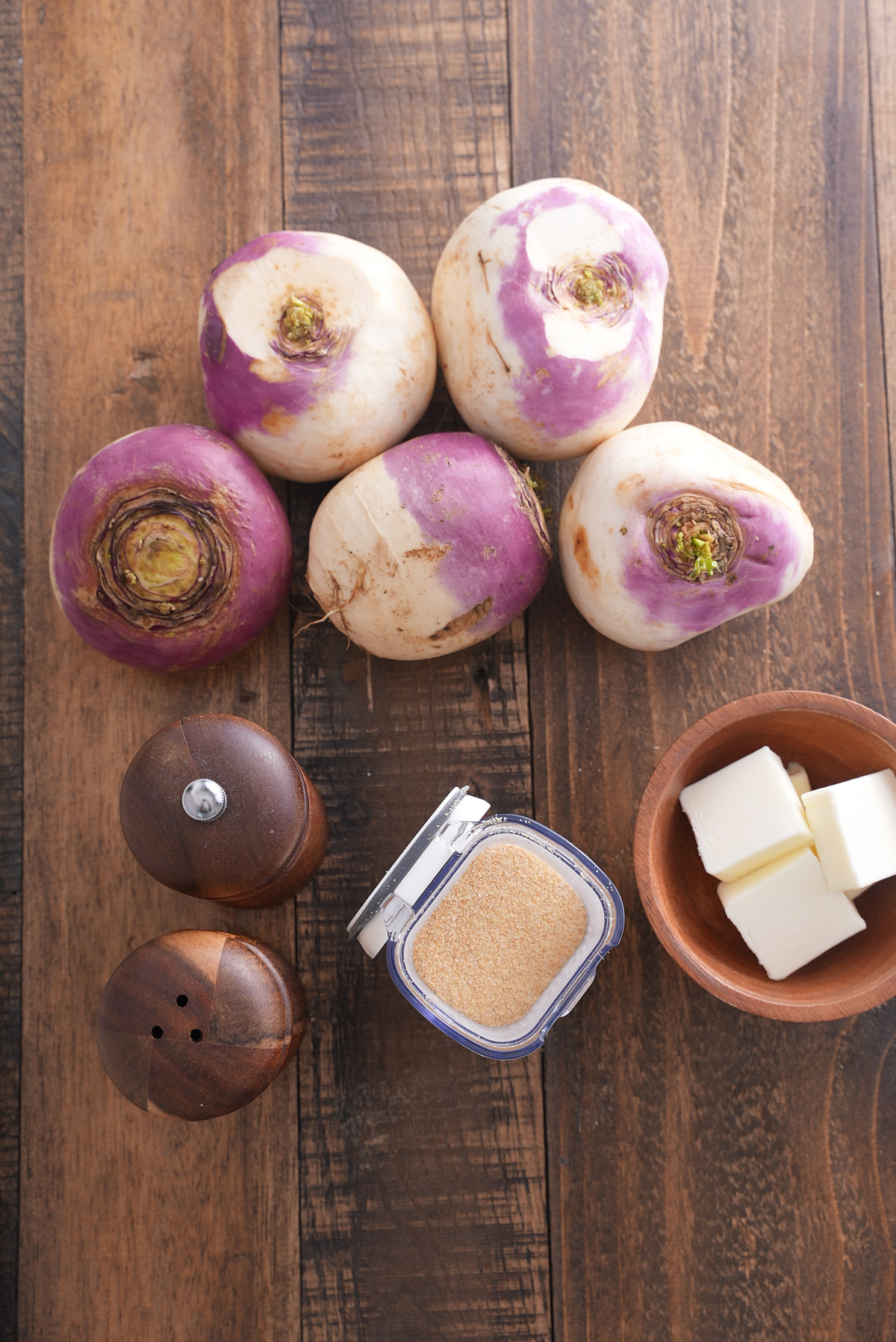 ingredients for mashed turnips on a wooden cutting board