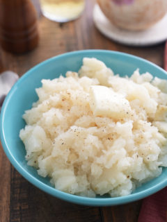 mashed turnips on blue plate with turnip in background