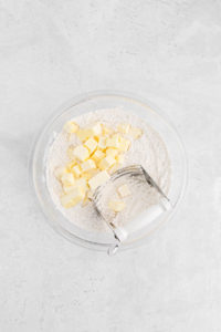 Cubed butter in large mixing bowl with flour