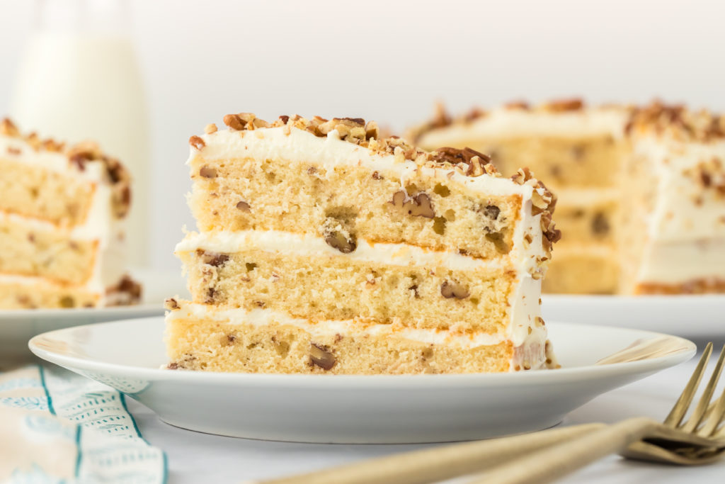 A slice of Butter Pecan Layer Cake Recipe on a white plate ready to enjoy