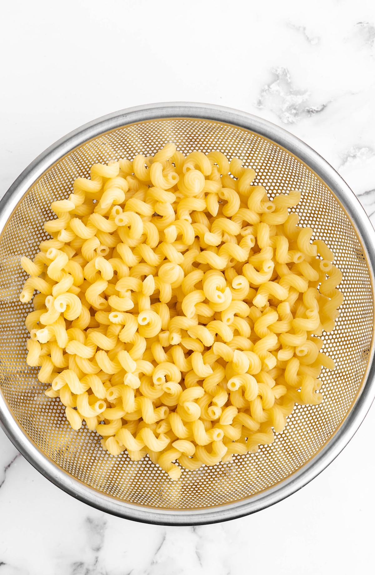 Overhead view of drained pasta in colander