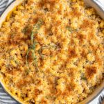 Overhead view of vegan mac and cheese in skillet, topped with breadcrumbs