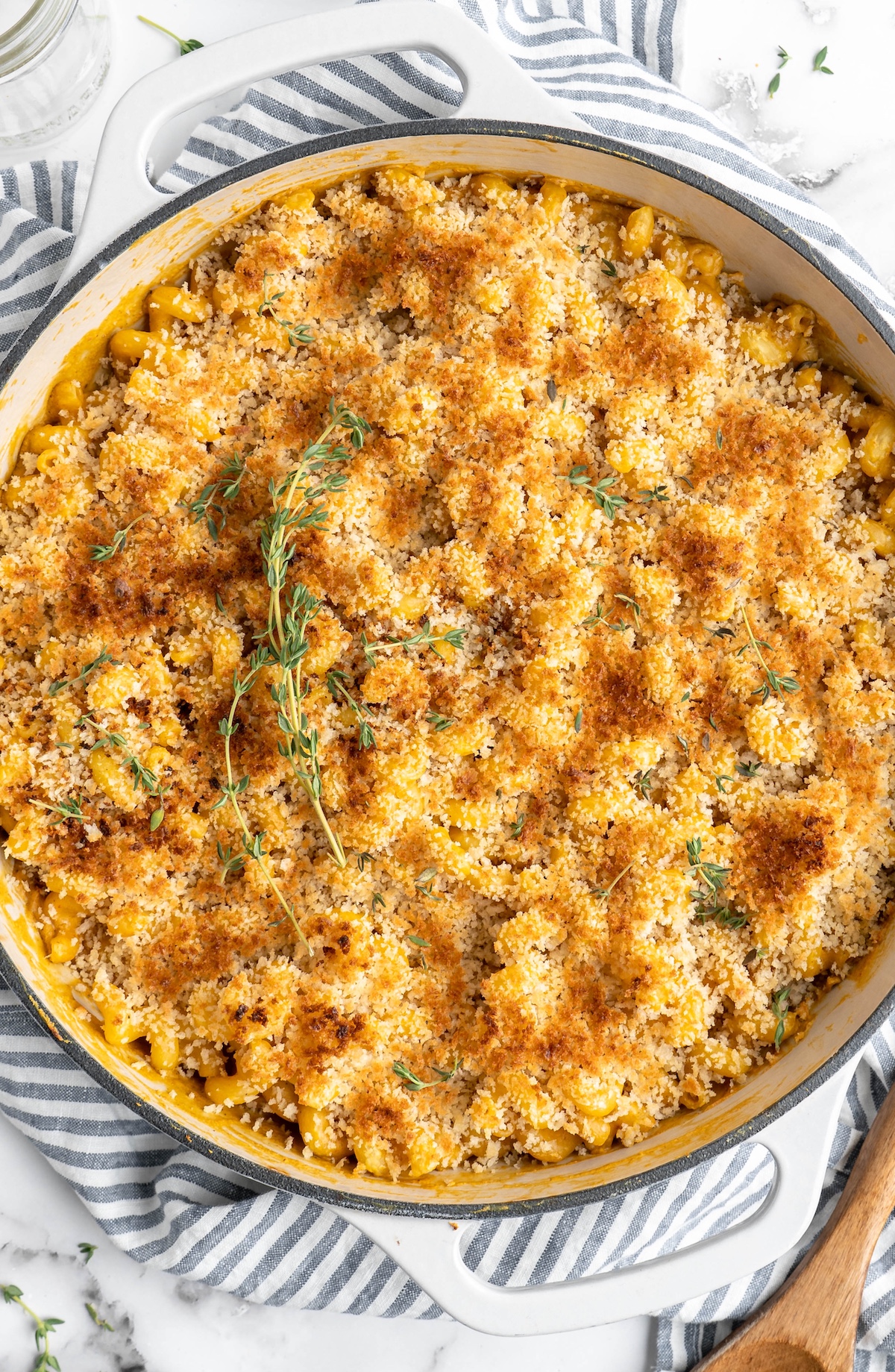Overhead view of vegan mac and cheese in skillet, topped with breadcrumbs