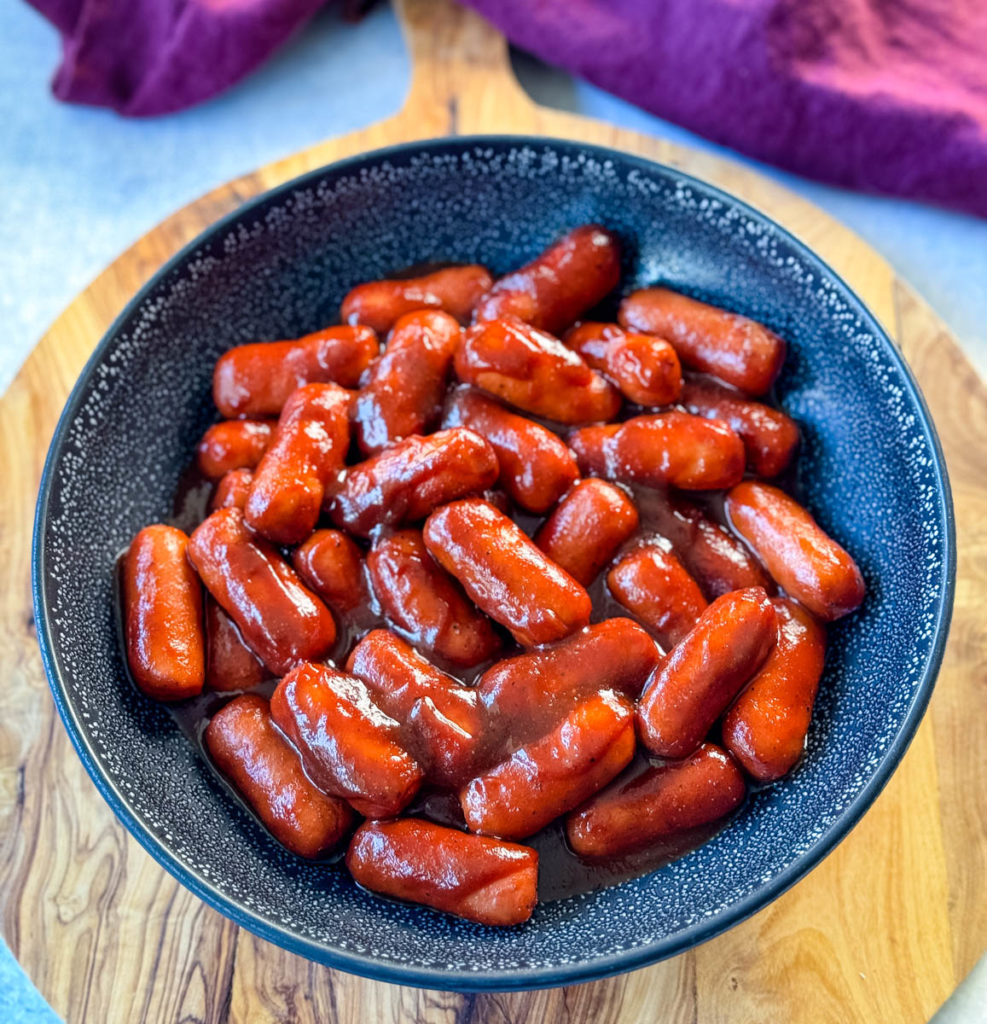little smokies and BBQ sauce in a black bowl