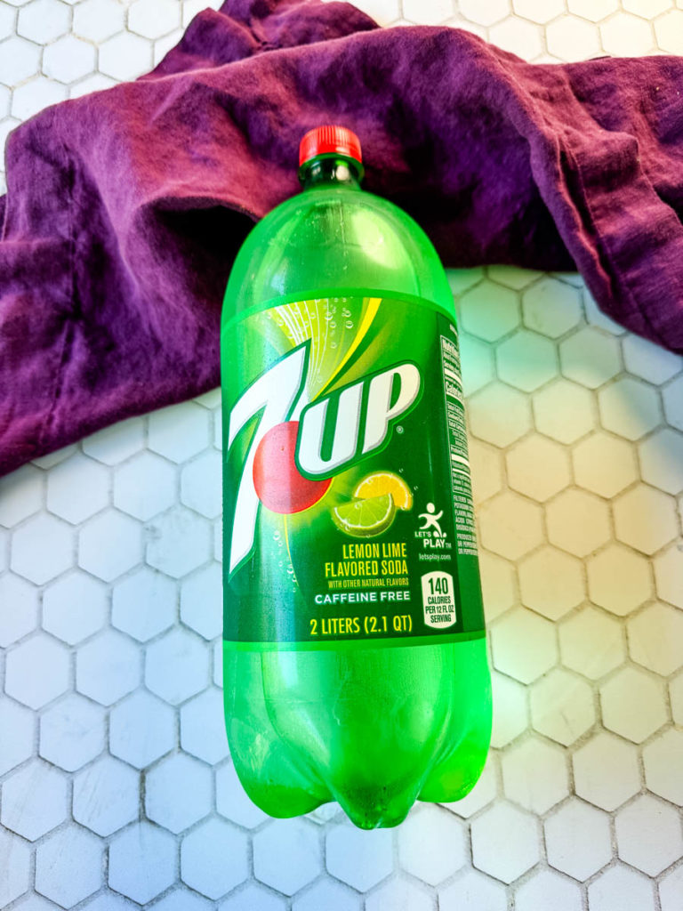 a bottle of 7up soda on a flat surface