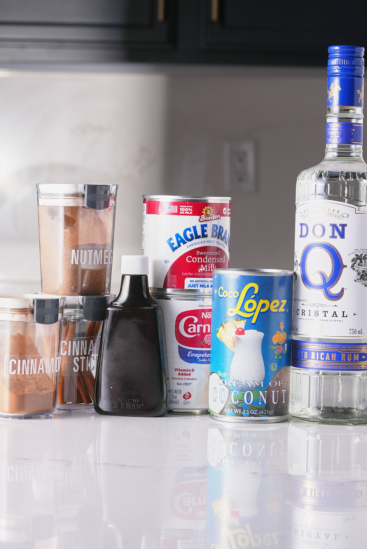 ingredients to make coquito on a kitchen island