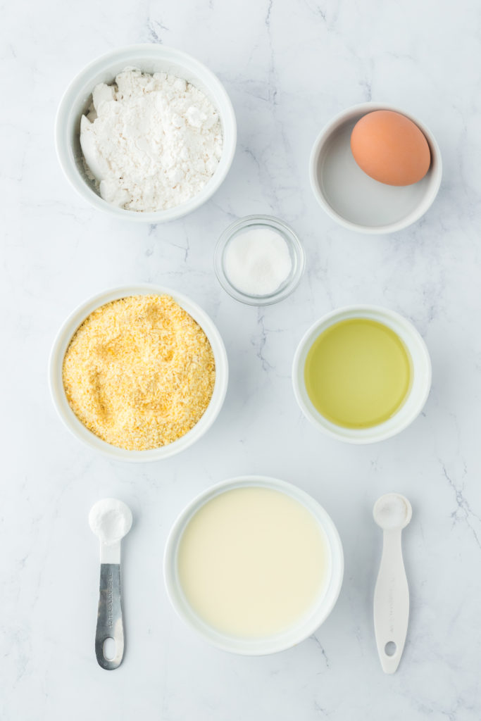 Ingredients in white bowls to make fried cornbread recipe