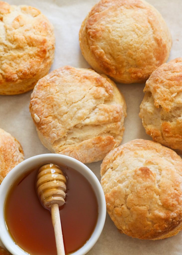 Insanely good Honey Butter Biscuits fresh from the oven with extra honey