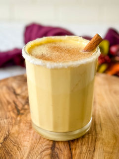 spiked eggnog in a glass with cinnamon