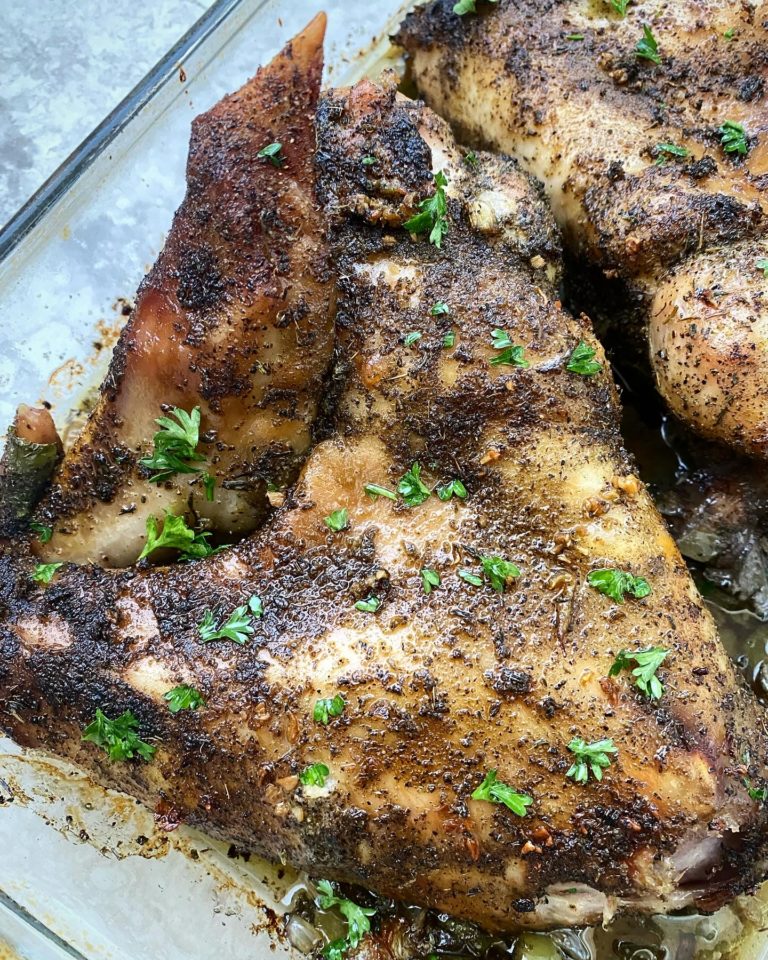 overhead shot of cooked turkey wing in a glass dish