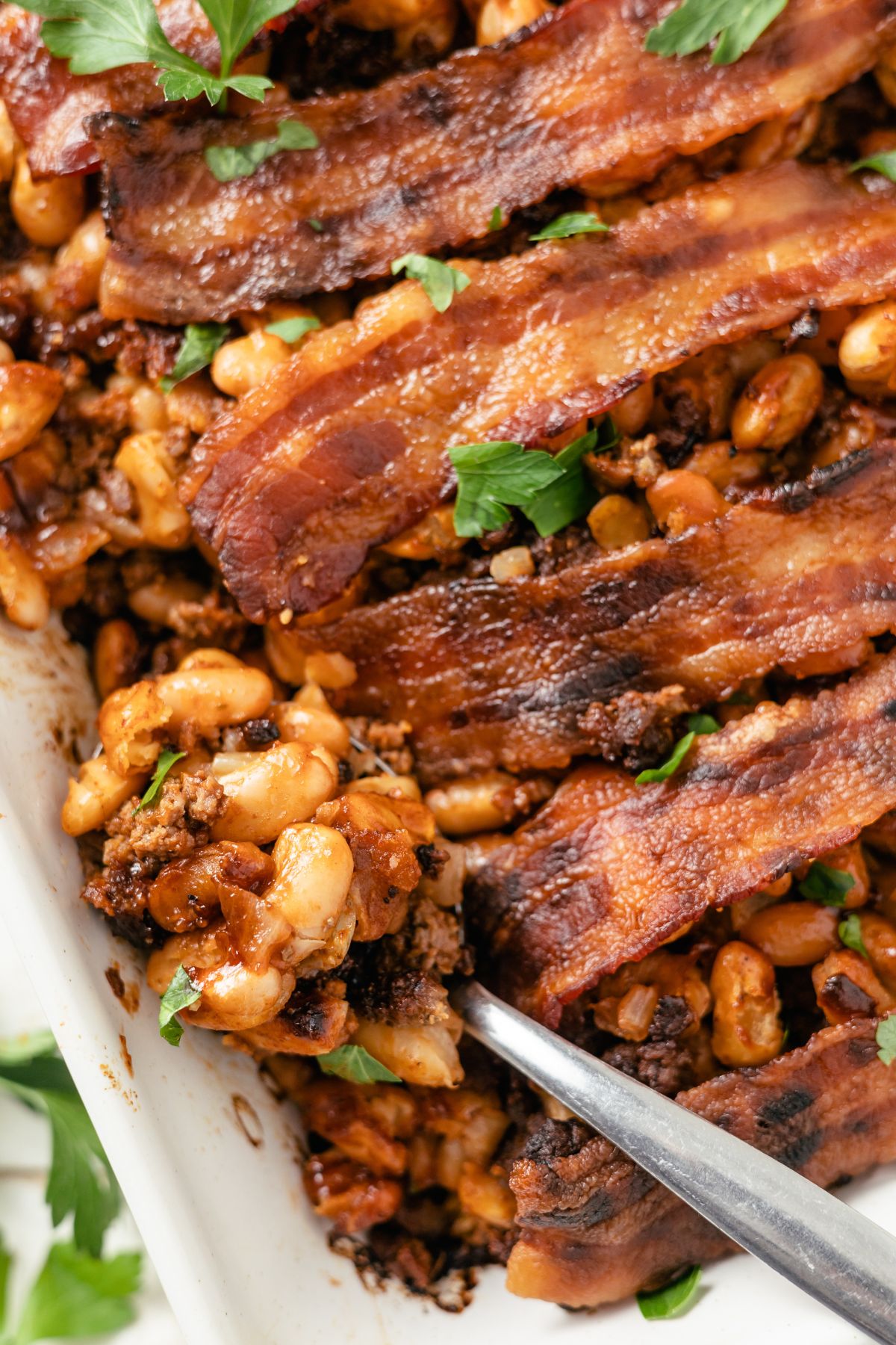 Savory baked beans with ground beef, topped with crispy bacon perfection.