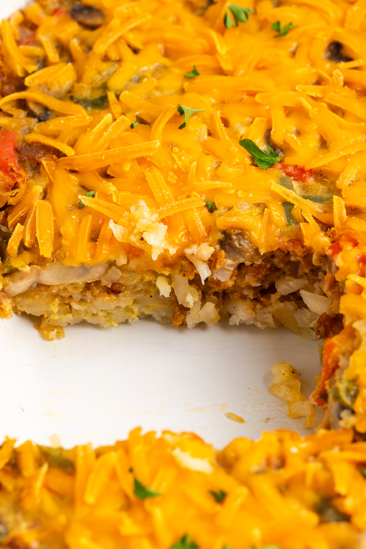Hashbrown breakfast casserole in dish with portion removed