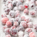 Sugared cranberries on rimmed baking sheet