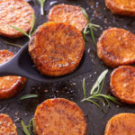 sweet potato slices on baking sheet after being baked