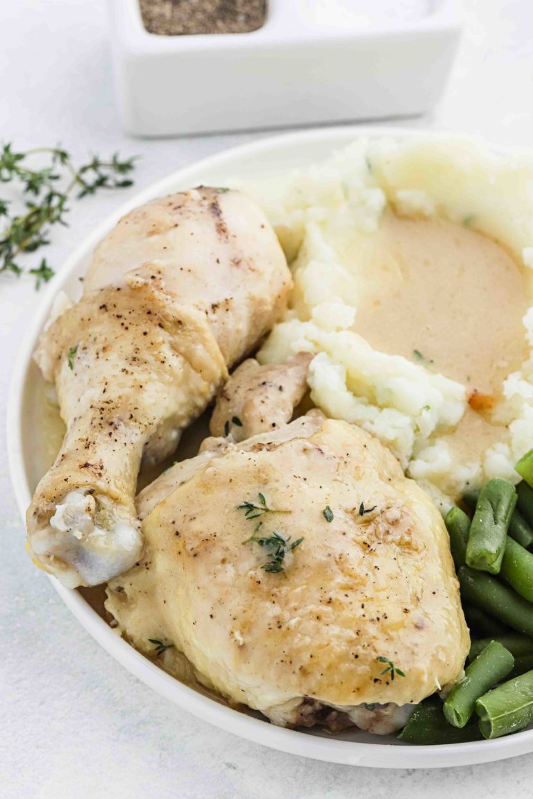 chicken and gravy plated with mashed potatoes and green beans.