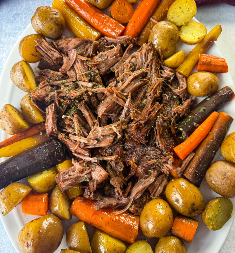 pot roast with carrots and potatoes on a platter