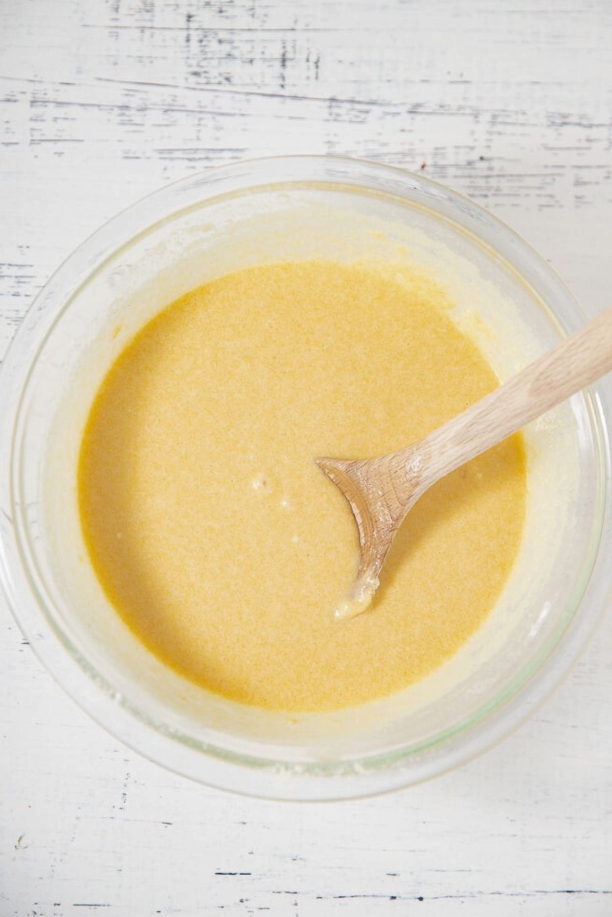 batter for cornbread muffins in bowl with spoon sticking out