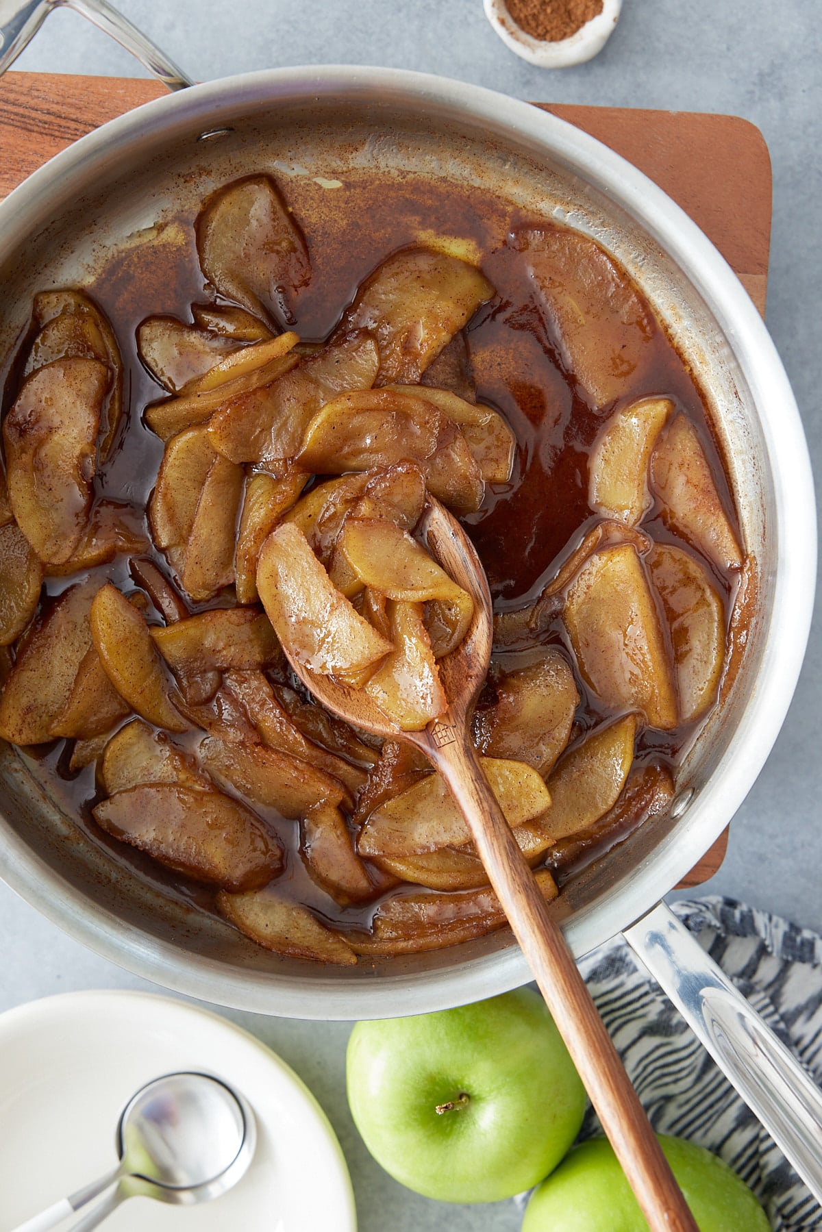 fried apples in skillet with whole apples on side