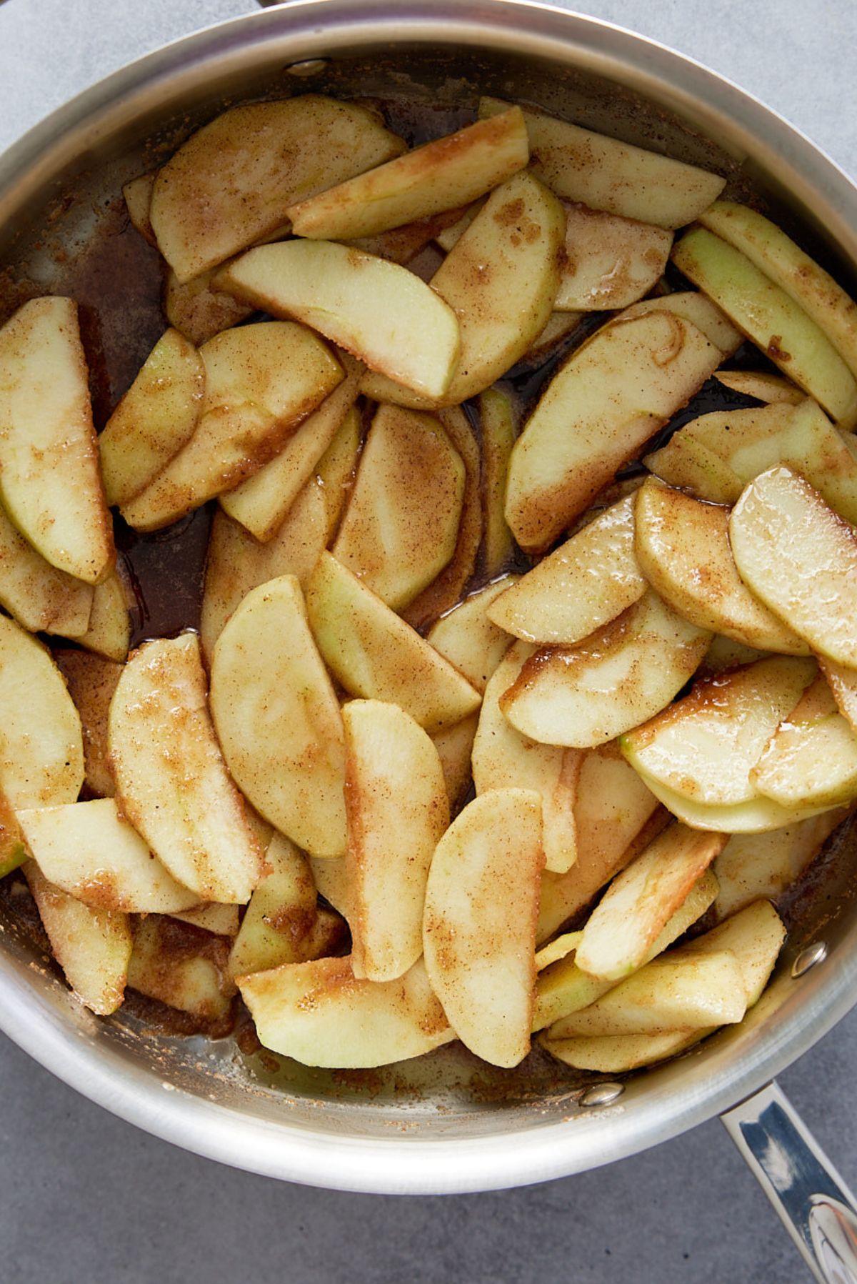 apples in skillet with brown sugar, spices, and butter, before cooking