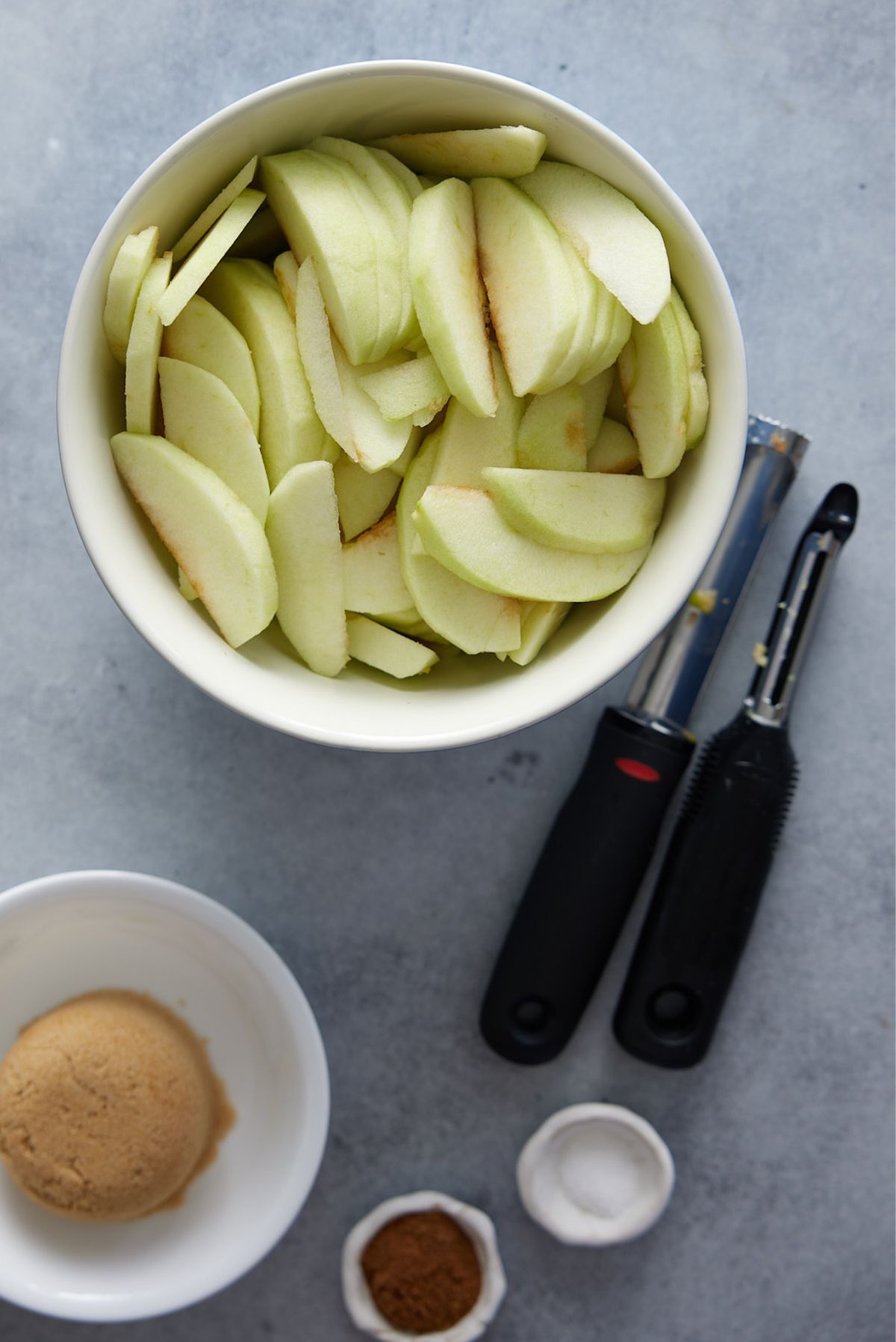ingredients for fried apples, included cut apples, brown sugar, apple pie spice, and salt