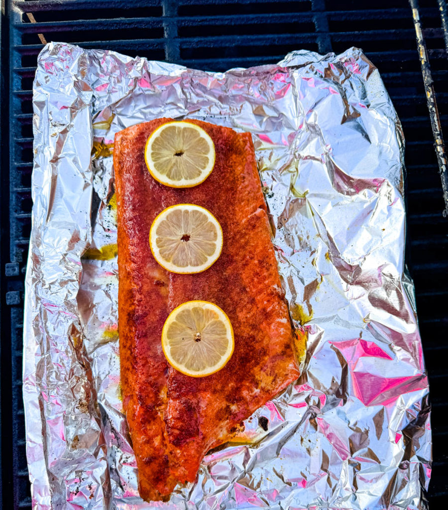 salmon with lemon on foil on the grill