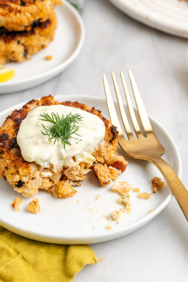 Vegan crab cake on white plate with fork