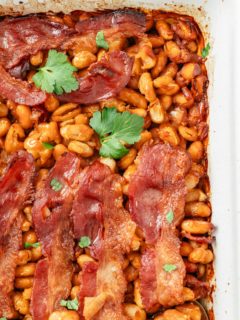 Baked beans in a baking dish, featuring a delightful blend of canned beans cooked to perfection in a flavorful sauce.