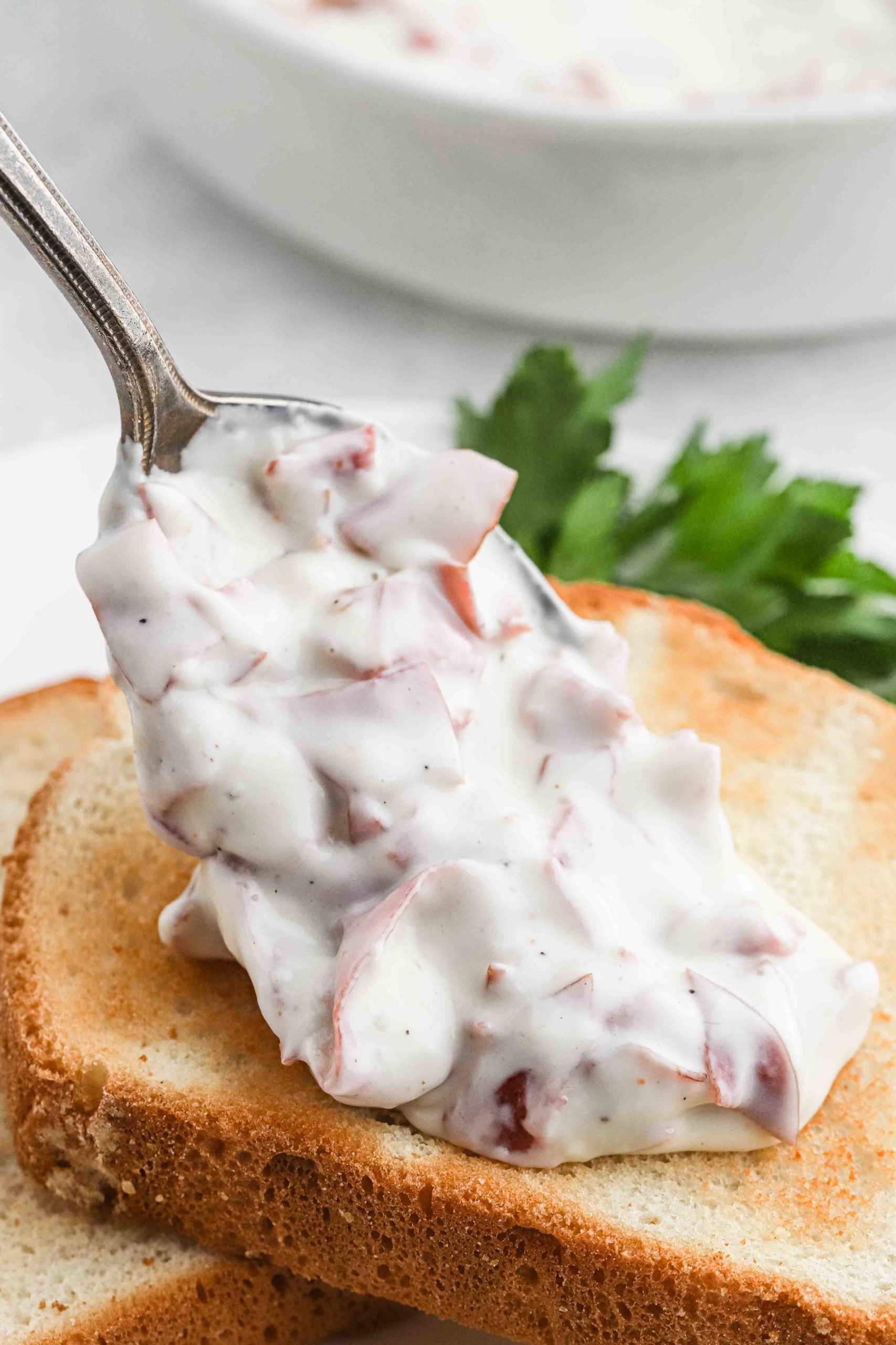 pouring chipped beef gravy over toast.