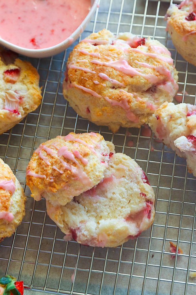 Slicing into a freshly glazed strawberry biscuit for a decadent breakfast treat