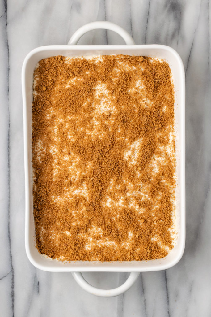 Overhead view of cinnamon sugar filling layer in pan