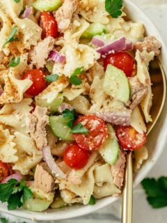 A close-up of a mouthwatering Canned Salmon Pasta Salad, showcasing tender pasta, flakes of flavorful salmon, and crisp vegetables, all tossed in a savory dressing