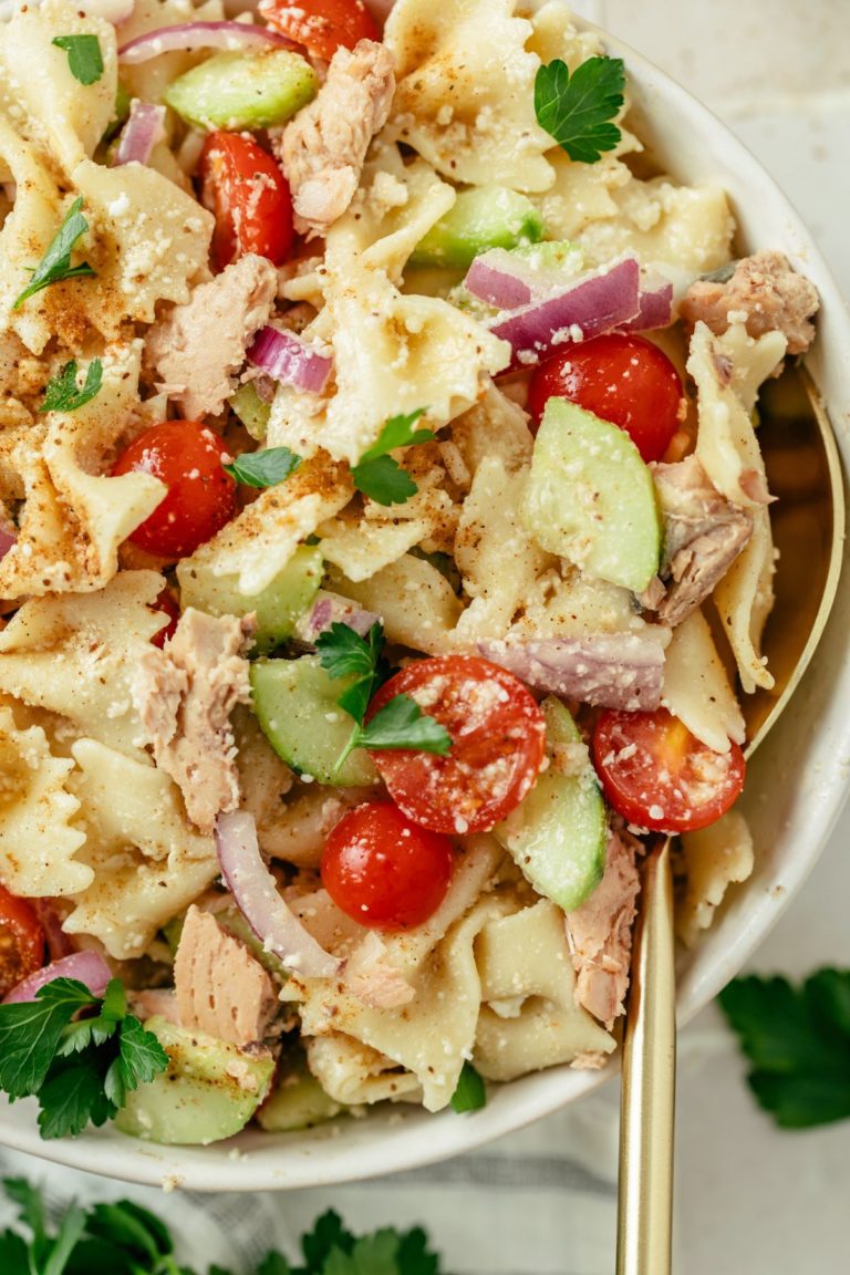 A close-up of a mouthwatering Canned Salmon Pasta Salad, showcasing tender pasta, flakes of flavorful salmon, and crisp vegetables, all tossed in a savory dressing