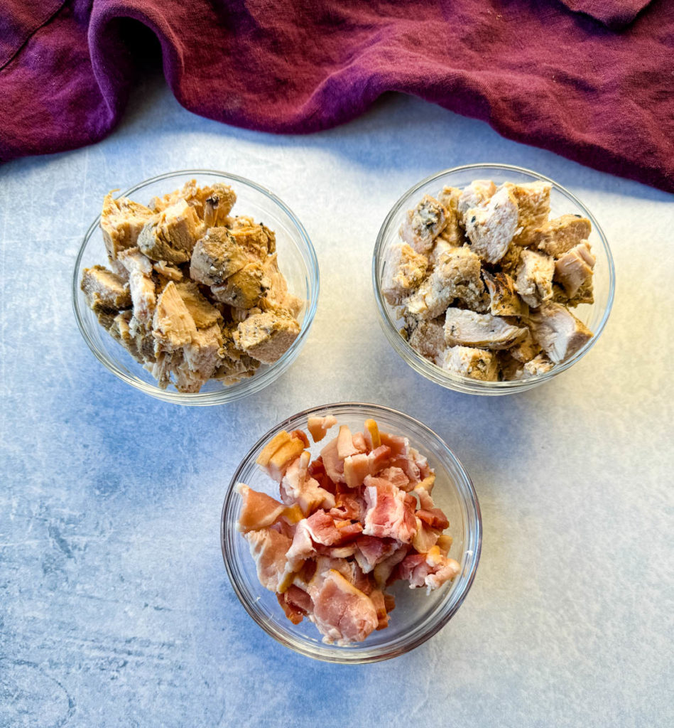 bacon and chicken in separate glass bowls