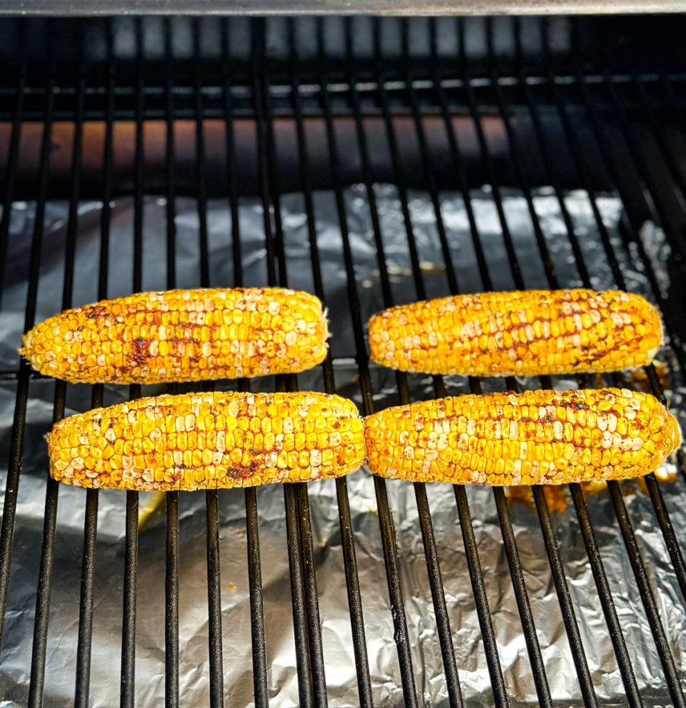 seasoned corn on the cob on a grill