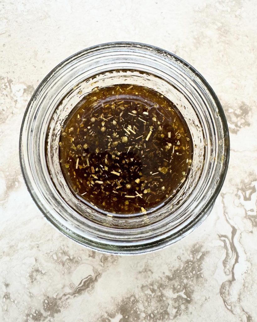 overhead shot of grilled vegetable marinade in a glass mason jar