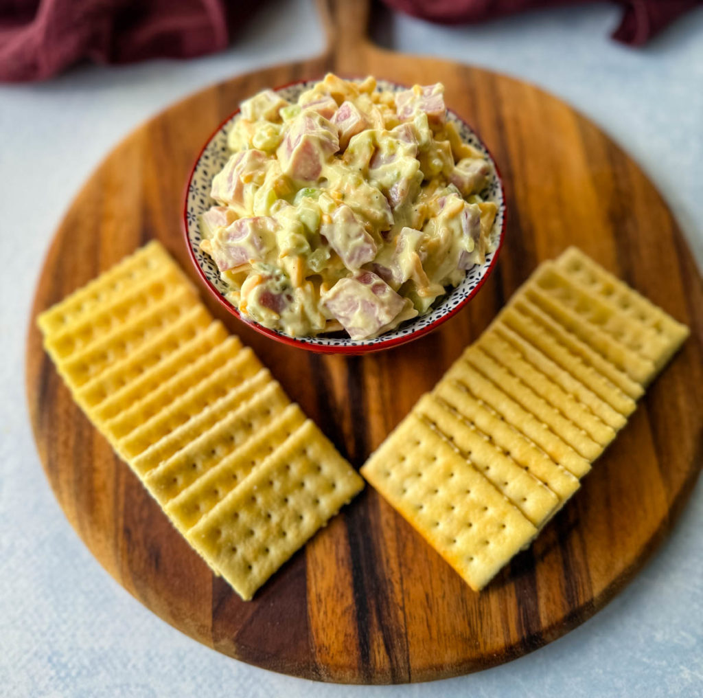 ham salad in a red bowl with crackers
