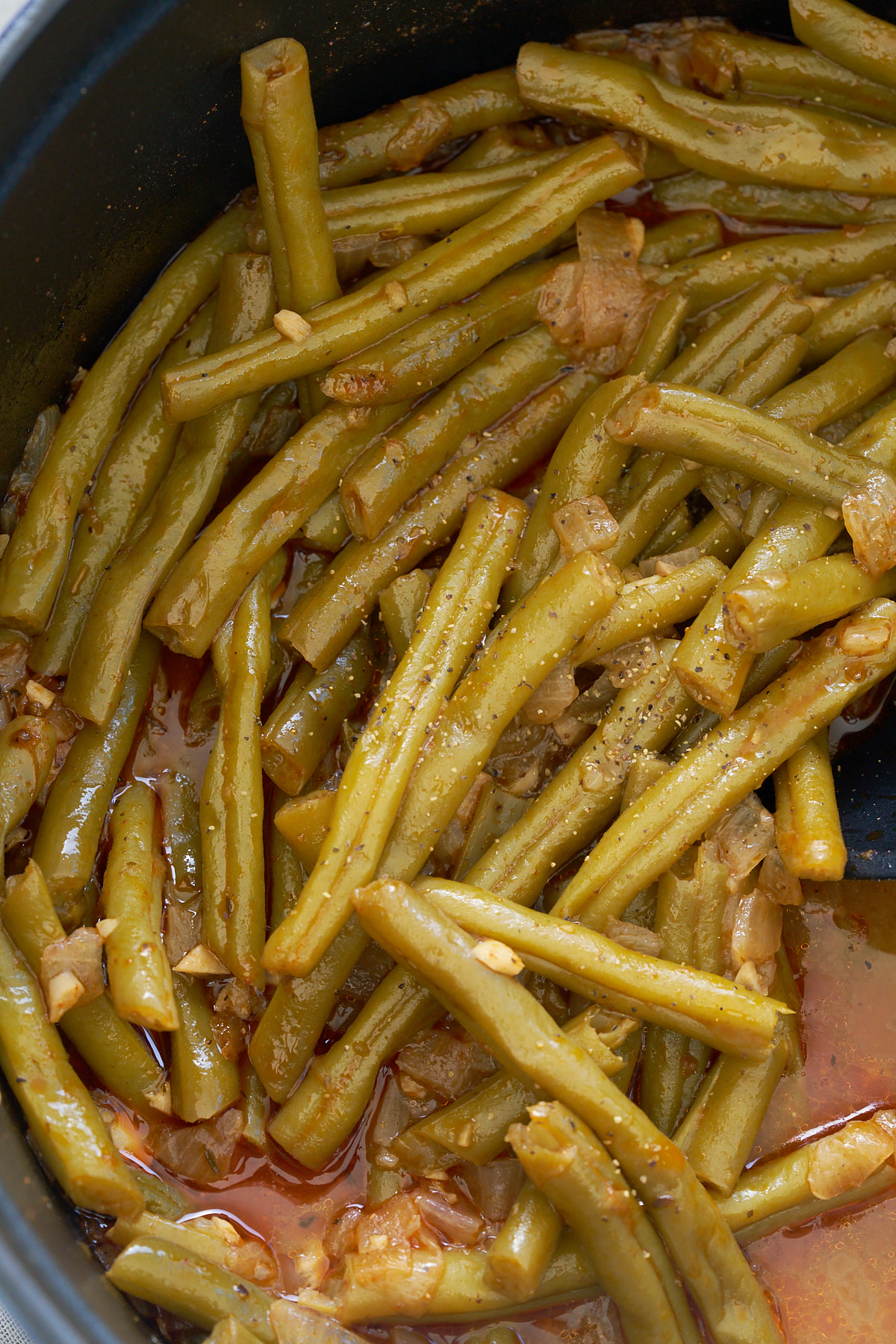 tender cooked green beans in sauce