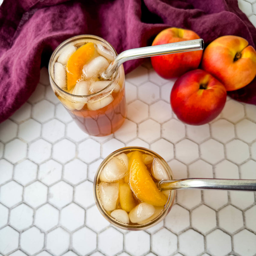 Southern sweet peach tea in glasses with a straw
